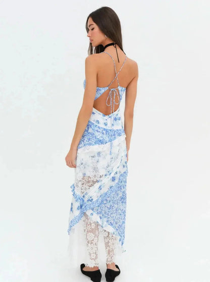 Back view of women's blue and white floral lace maxi dress showing criss-cross straps and open back
