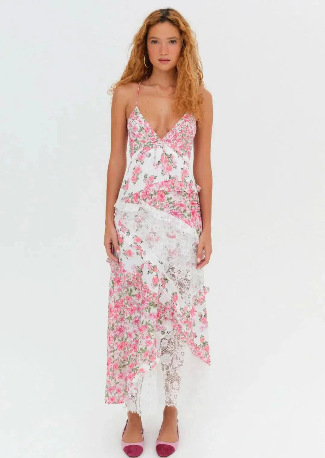 Front view of women's white and pink floral lace V-neck maxi dress with ruffled and criss-cross back design