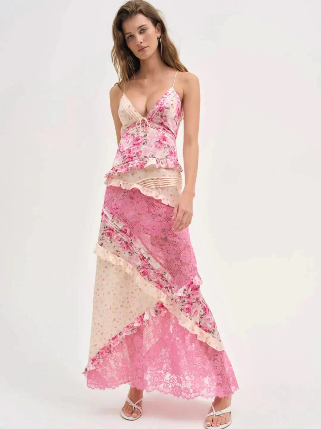 Front view of women's pink floral lace V-neck maxi dress with ruffled bodice and tiered skirt, ideal for vacation outfits
