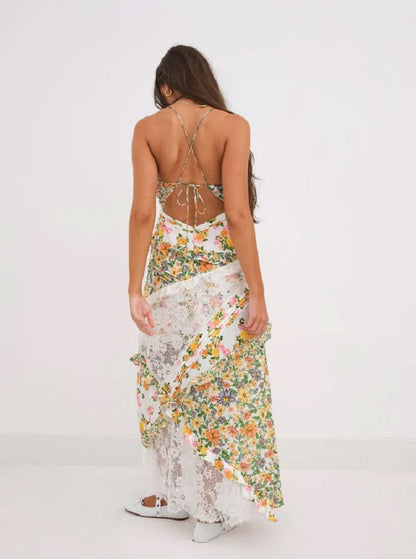 Back view of women's floral lace V-neck maxi dress in yellow and orange print with criss-cross back