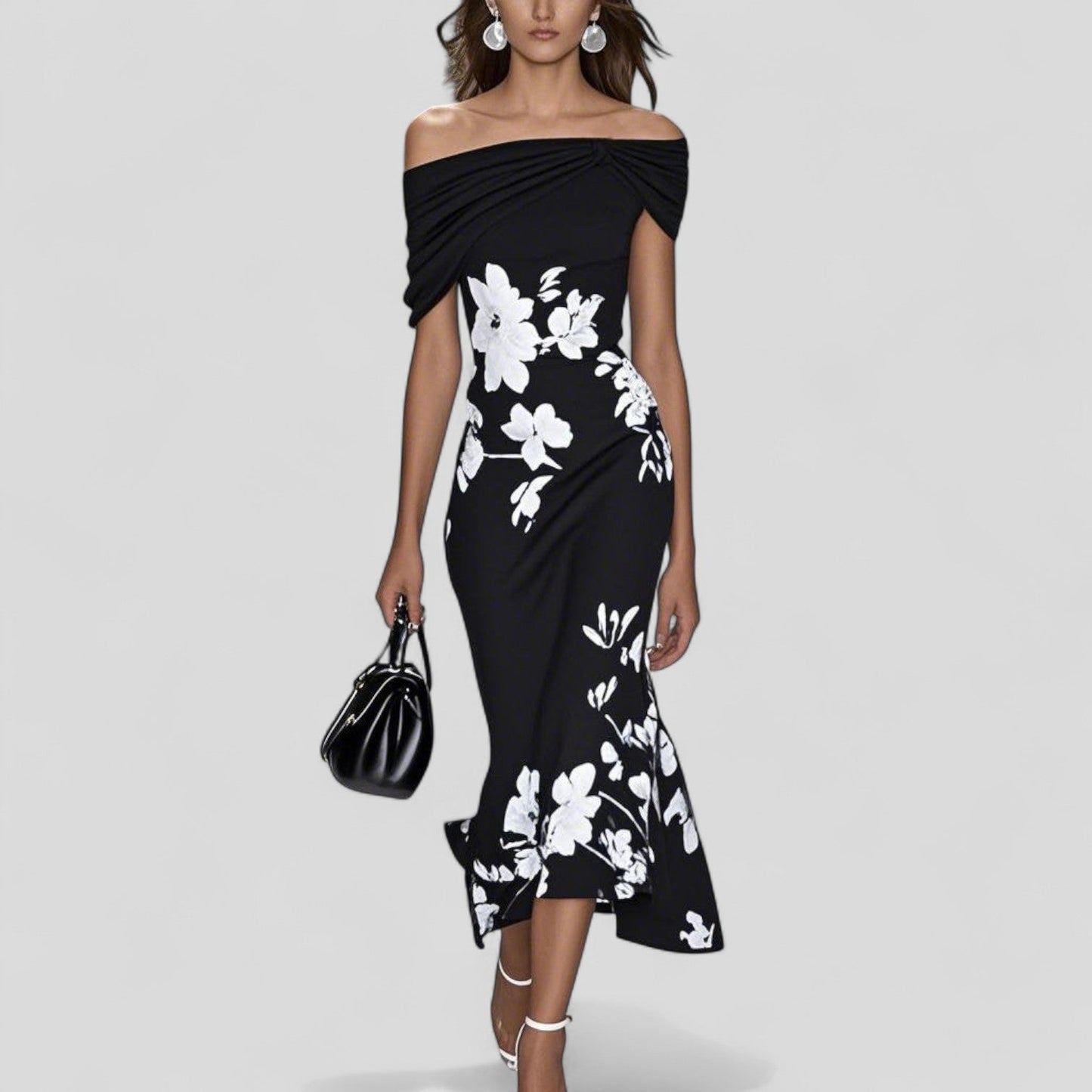 Black off-shoulder midi dress with white floral print, twisted bodice, and a high-low mermaid skirt. Stylish wedding guest dress.