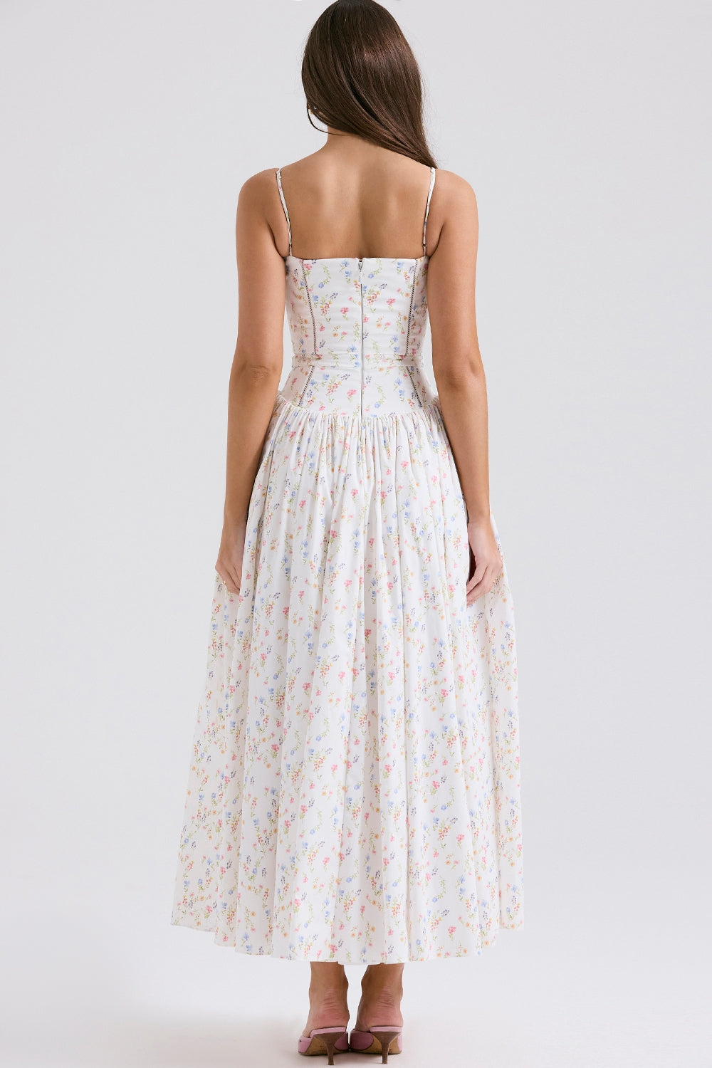 Back view of a white midi dress for women with a multi-color floral print, square neckline, and a flowing skirt.
