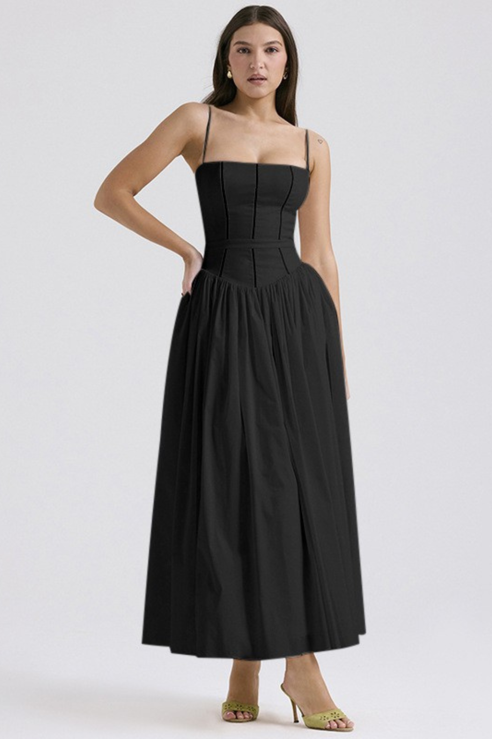 Front view of a black square neck midi dress with thin straps and a structured bodice, featuring a flowing A-line skirt, suitable for elegant dresses for wedding guests.