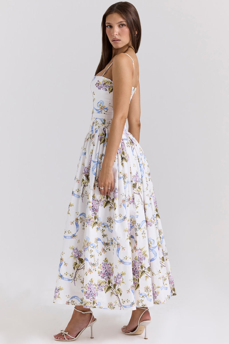Side view of a sleeveless white floral midi dress with square neckline and gathered skirt, perfect for vacation outfits.