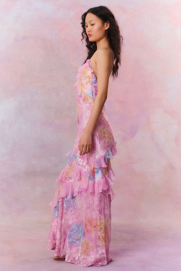 Side profile of the pink floral ruffle strap maxi dress, emphasizing the tiered ruffles and vibrant floral print.
