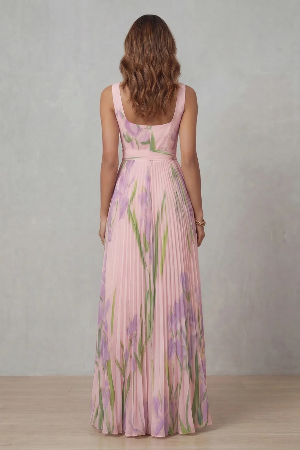 Back view of a women's pink floral square neck maxi dress, showcasing the pleated details and elegant design.