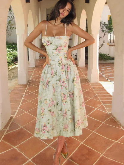 Women's floral sweetheart neck pleated midi dress in light green with pink and yellow flowers, full body shot.