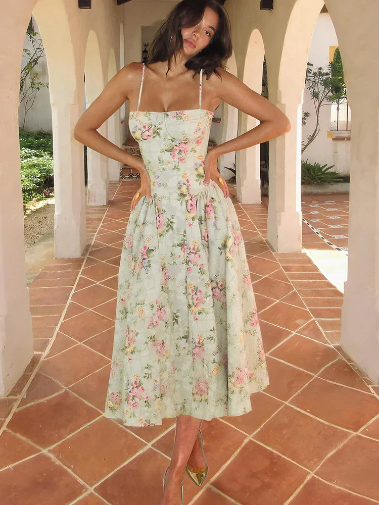 Women's floral sweetheart neck pleated midi dress in light green with pink and yellow flowers, full body shot.