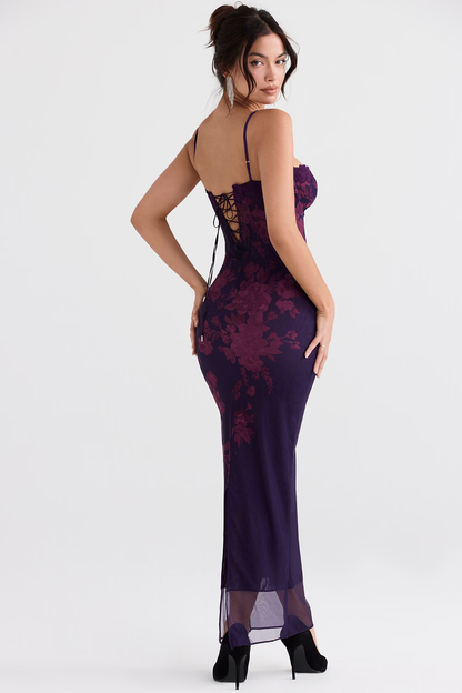 Back view of purple floral spaghetti strap maxi dress with lace-up corset detail and sheer hem