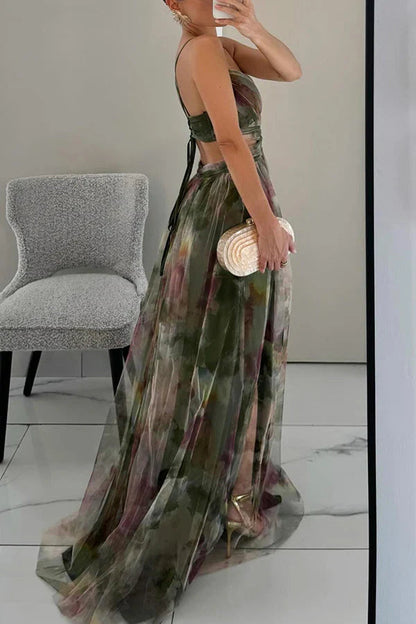 Side and back view of a women's green floral maxi dress, showing the lace-up back and flowing skirt with a high slit.