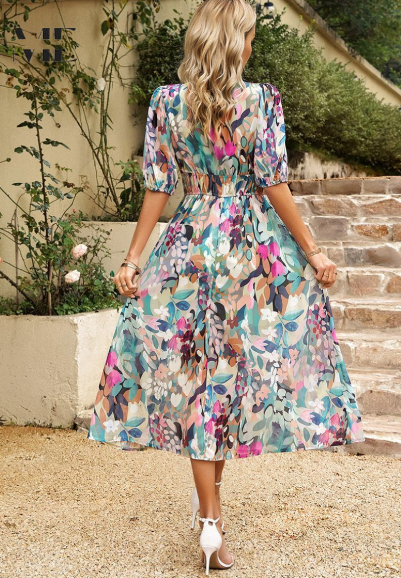 Back view of the women's floral v-neck midi dress, showcasing the elasticated waist and flowy skirt, ideal for vacation dresses.