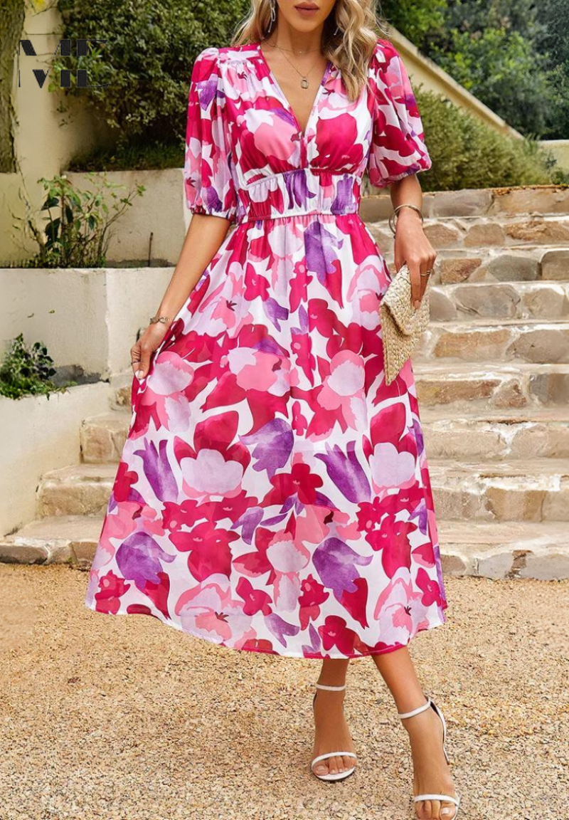 Women's pink and purple floral v-neck midi dress with short sleeves, cinched waist, and a full skirt, great for a midi wedding guest dress.