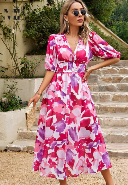 Side profile of the women's pink and purple floral v-neck short sleeve midi dress, displaying the elegant V-neckline and comfortable design.