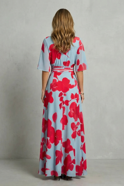 Back view of women's light blue and red floral maxi dress, showing defined waistband and full pattern