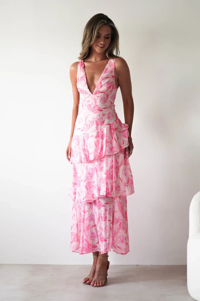 Full-length front view of a women's pink summer floral V-neck tiered maxi dress, showcasing the tiered skirt and V-neck.