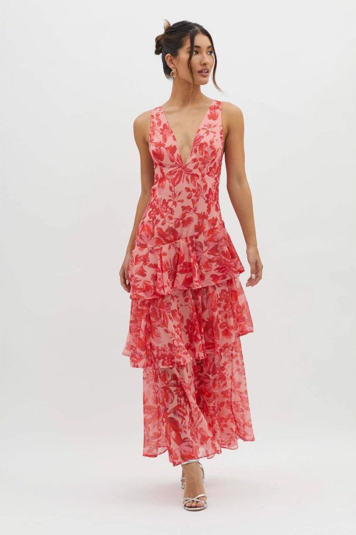 Women's summer floral v-neck tiered maxi dress in a vibrant pink and red floral print, with a deep v-neck and ruffled skirt.
