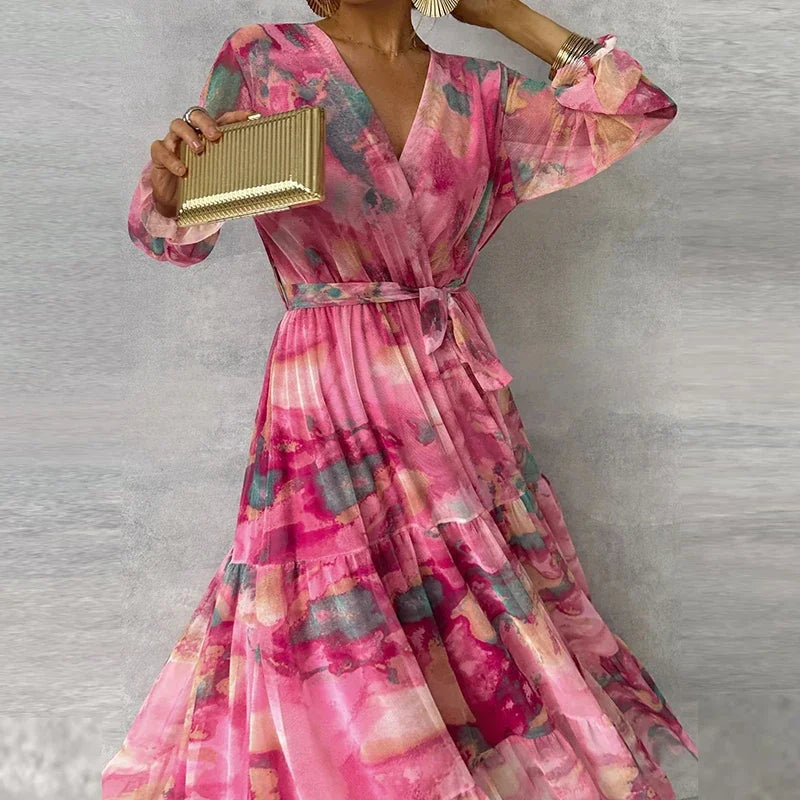 Close front view of pink floral wrap maxi dress showing tie belt waist, v-neckline, and sheer sleeves