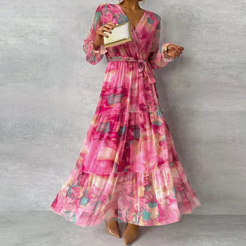 Full length front shot of pink floral summer maxi dress with tiered hem, wrap v-neck, and waist sash