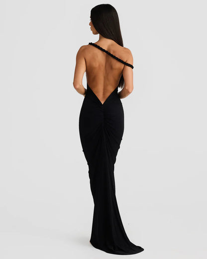 Back view of black bodycon maxi dress with deep V open back, ruched detail, and train hem