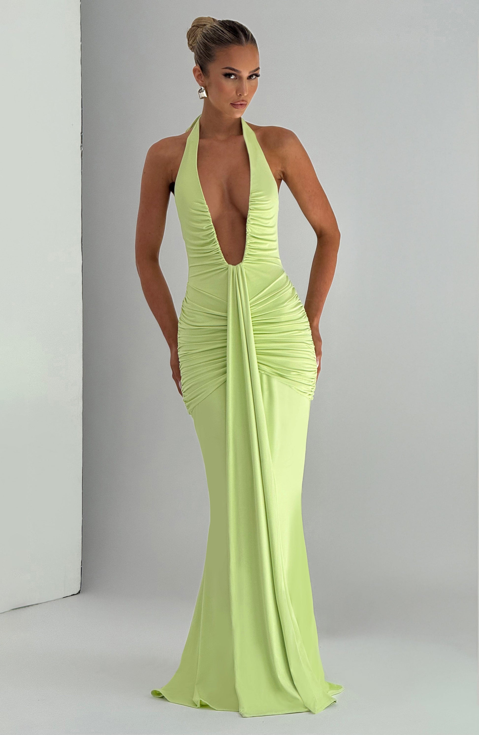 Front view lime green formal halter maxi dress with deep V plunge, ruched hips, long scarf panel