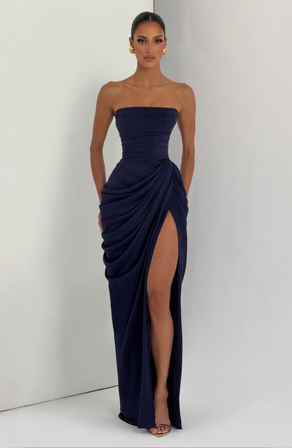 Full-length navy strapless formal maxi dress with side draping and thigh-high slit front view