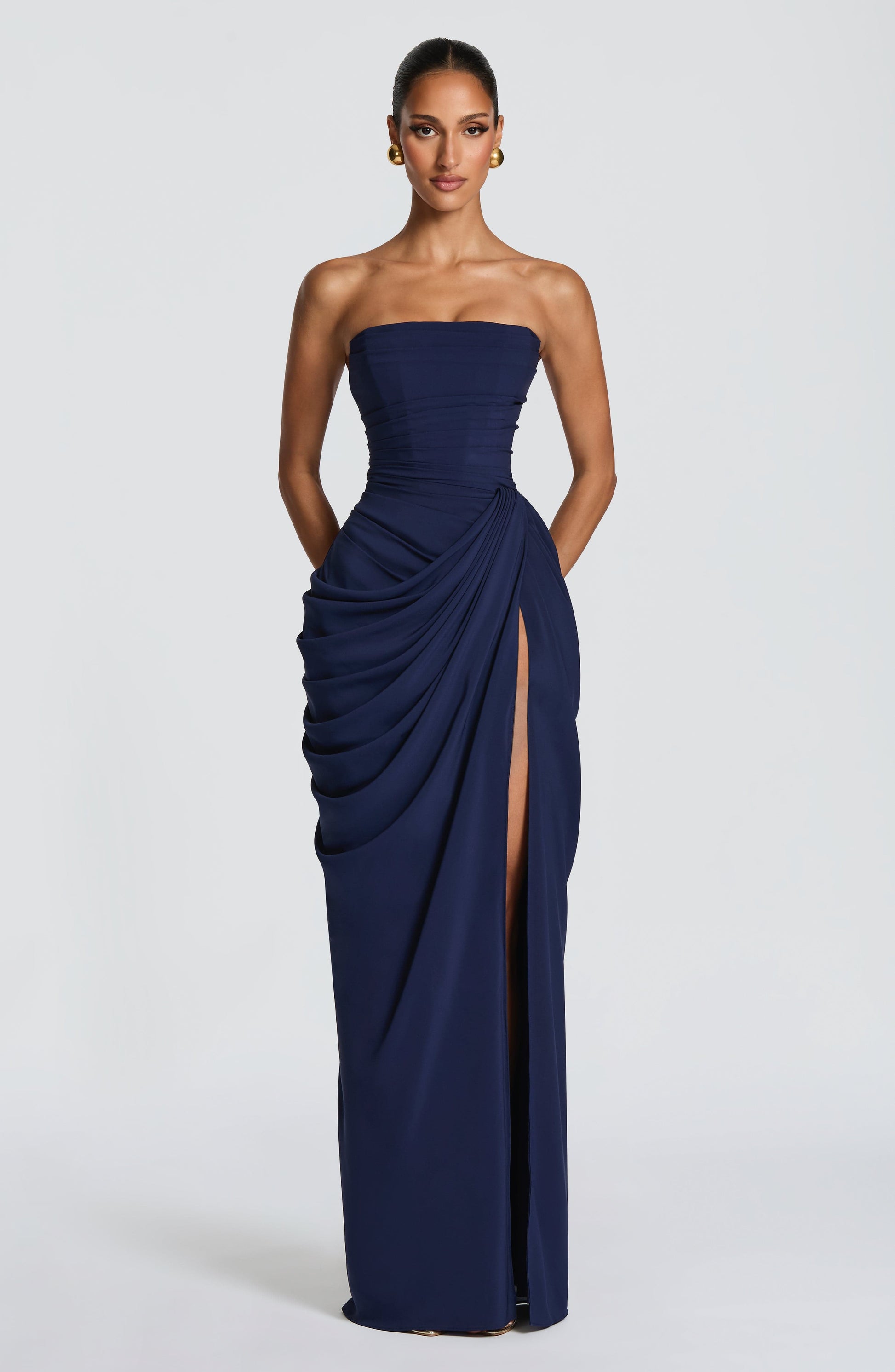 Navy strapless draped bodycon maxi dress with ruched hip drape and high leg slit, front view