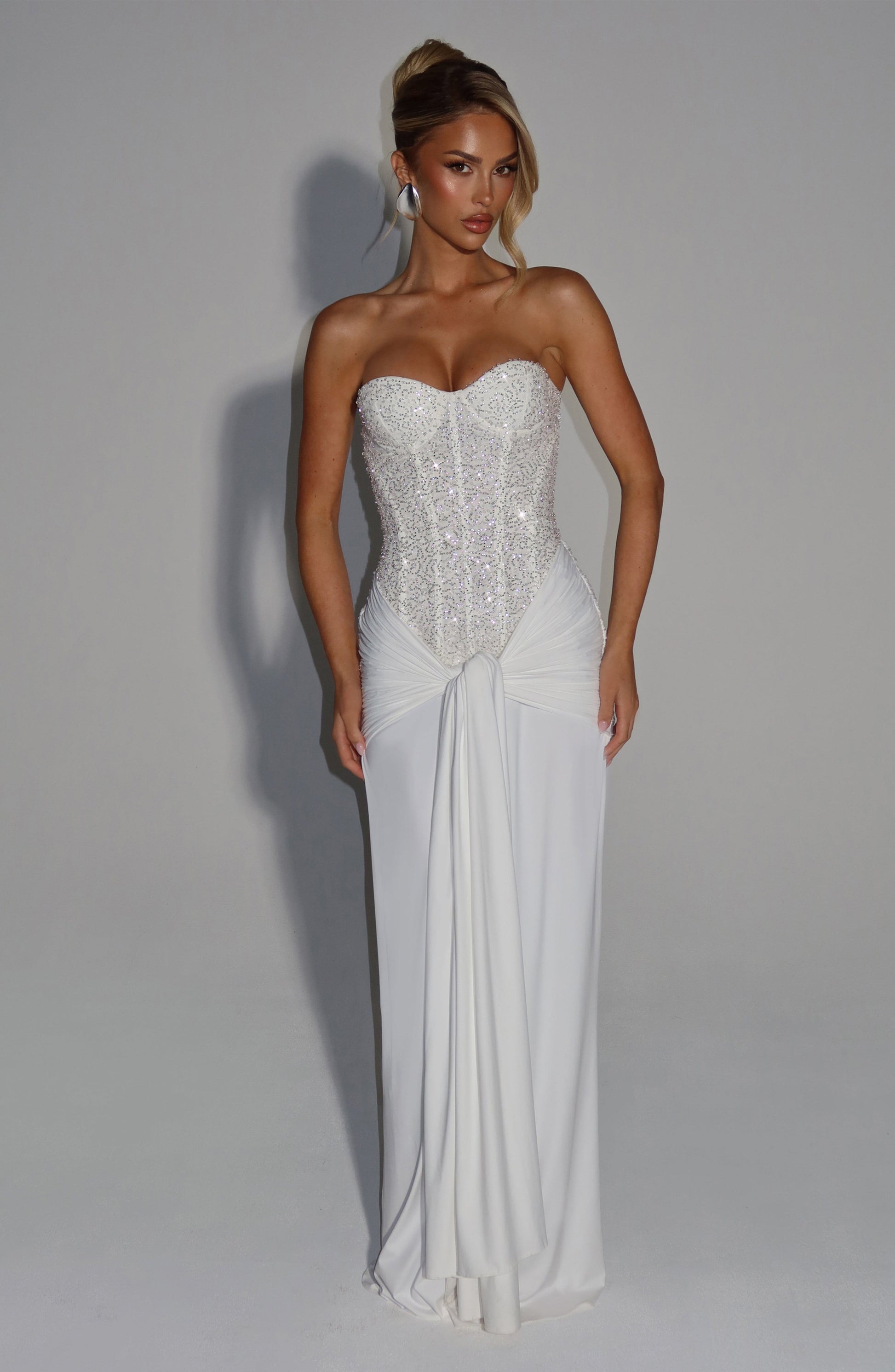 White formal strapless sequin corset maxi dress with sweetheart neckline and center front drape panel