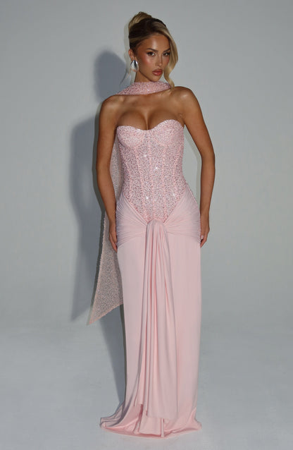 Front view of blush pink strapless sequin corset maxi dress with sweetheart bust and draped waist sash