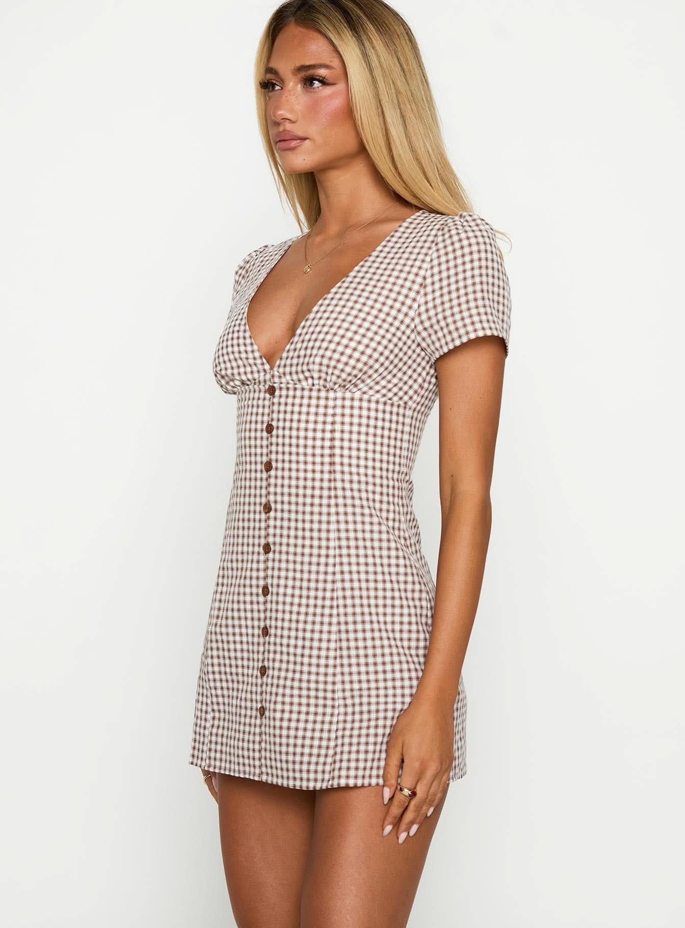 Side view of brown gingham V-neck mini playsuit showing fitted waist and short puff sleeves
