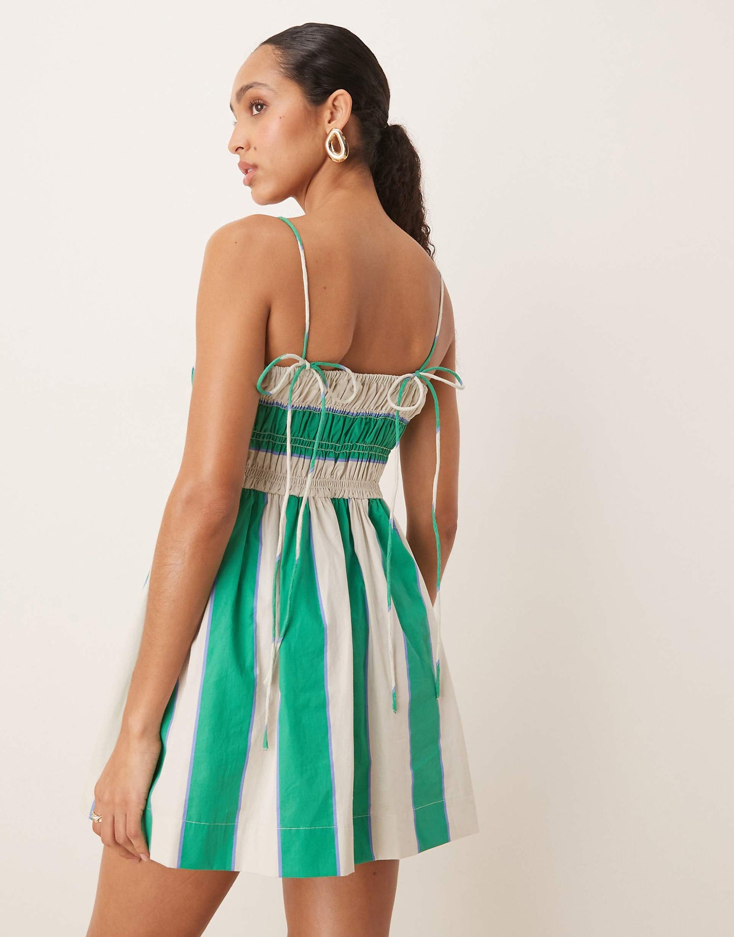 Women striped square neck mini dress with thin straps and gathered skirt, side view