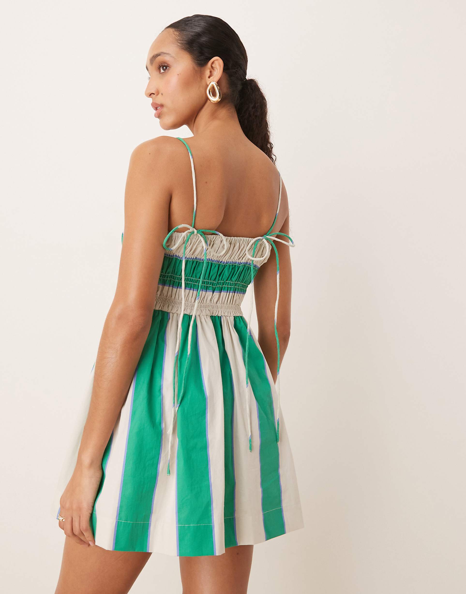 Women striped square neck mini dress with thin straps and gathered skirt, side view