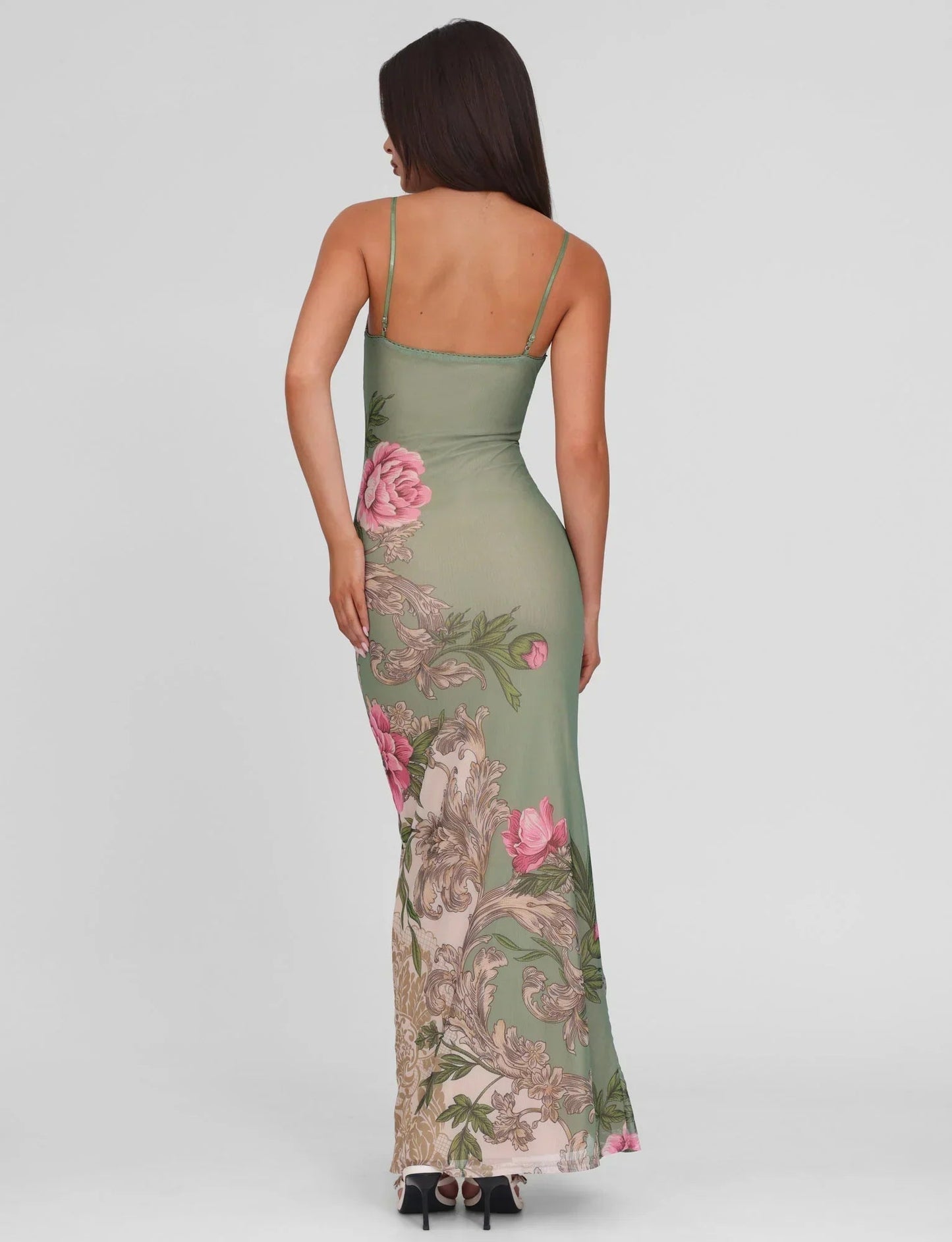 Back view of sage green floral maxi dress with thin straps and fitted waist, floor length