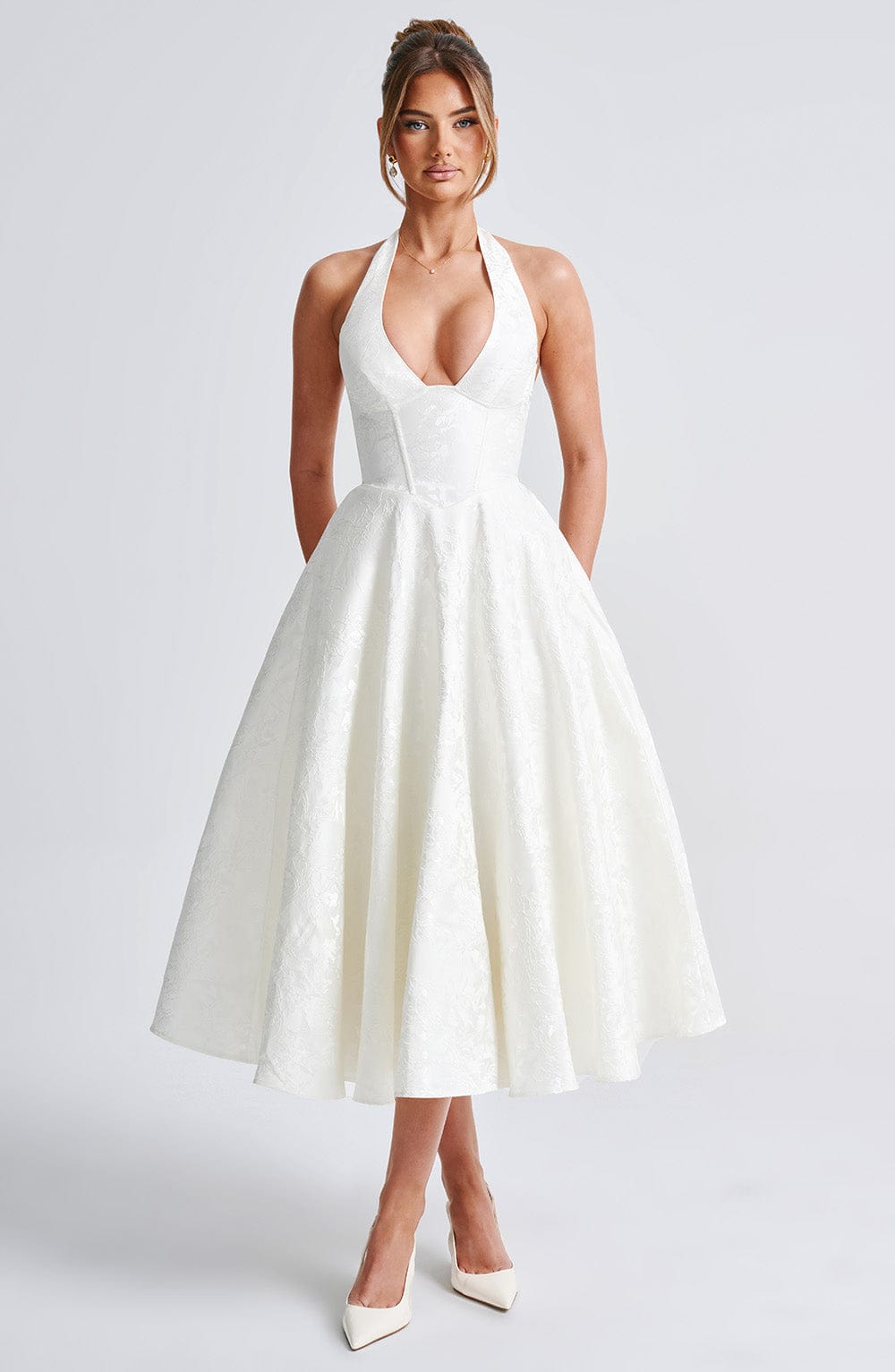 Elegant white jacquard halter neck midi dress with a fitted bodice and a flowing skirt, ideal as a white dress.