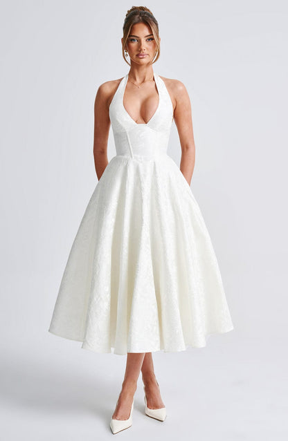 Elegant white jacquard halter neck midi dress with a fitted bodice and a flowing skirt, ideal as a white dress.