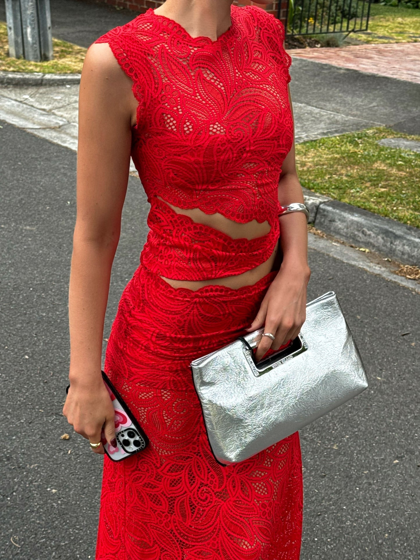 Front detail red lace sleeveless top and maxi skirt set showing layered waist cut out panels