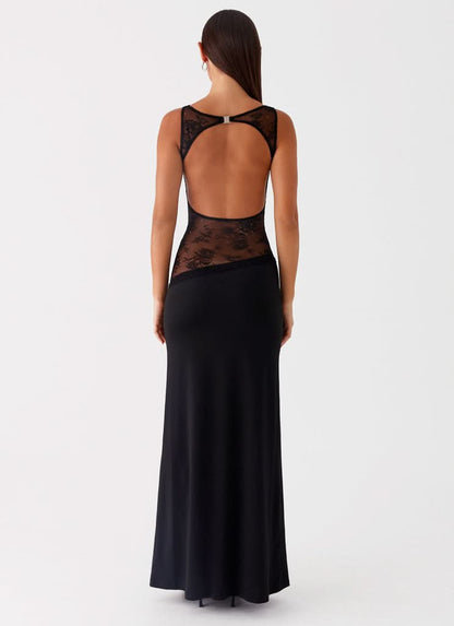 Back view of black cocktail maxi dress with open back and sheer floral lace panels.