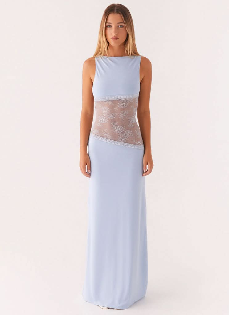 Light blue sleeveless cocktail maxi dress with sheer white floral lace cutout waist, front view.