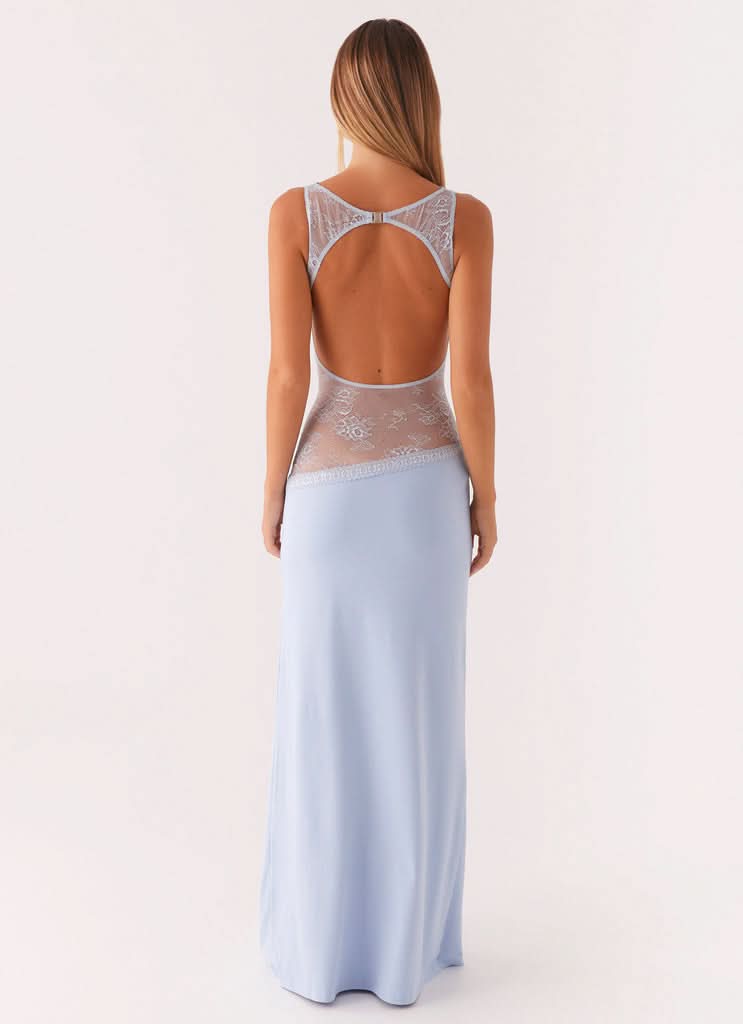 Back view of light blue cocktail maxi dress with open back and white floral lace details.