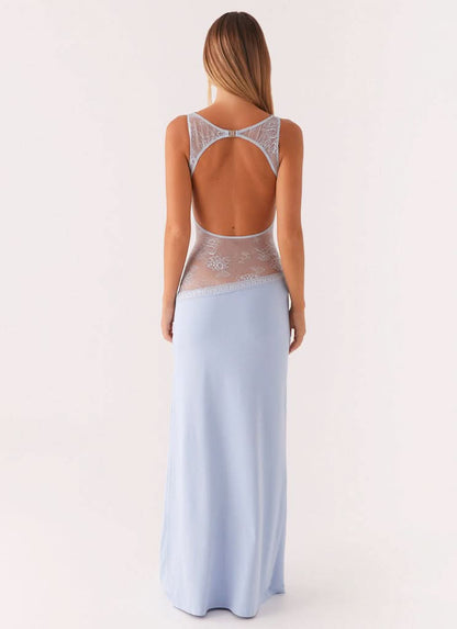 Back view of light blue cocktail maxi dress with open back and white floral lace details.