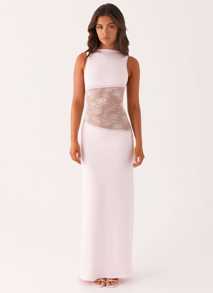 Pale pink sleeveless cocktail maxi dress with sheer white floral lace cutout waist, front view.
