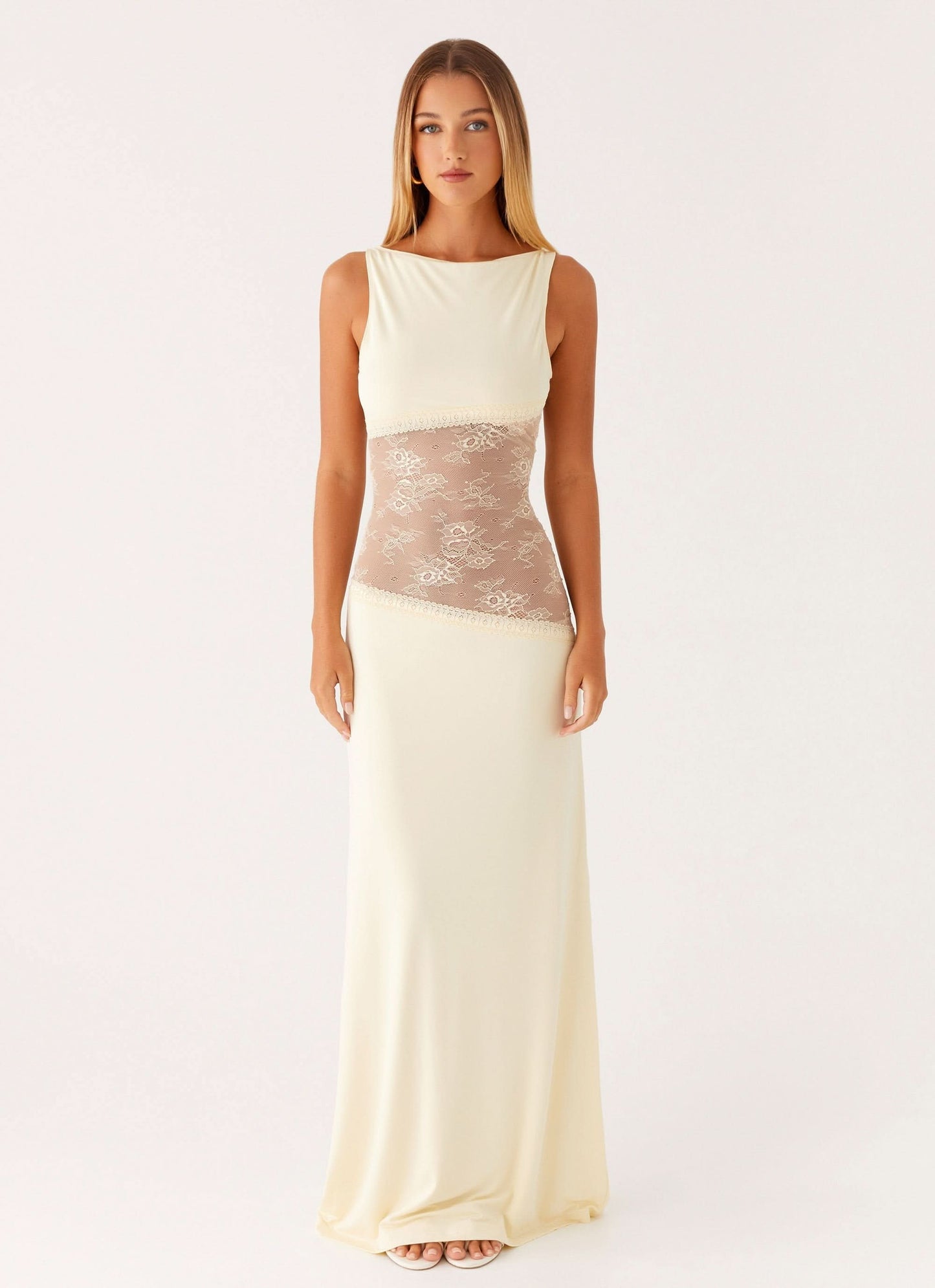 Cream white sleeveless cocktail maxi dress with sheer beige floral lace cutout waist, front view.