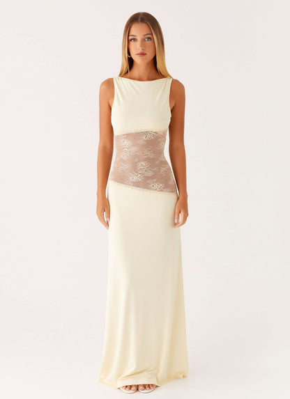 Cream white sleeveless cocktail maxi dress with sheer beige floral lace cutout waist, front view.