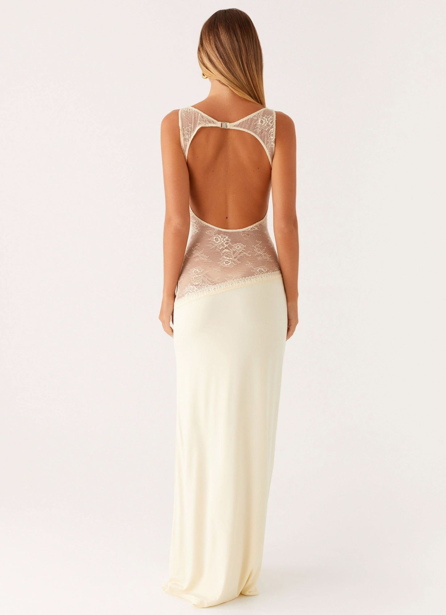 Back view of cream white cocktail maxi dress with open back and beige floral lace details.