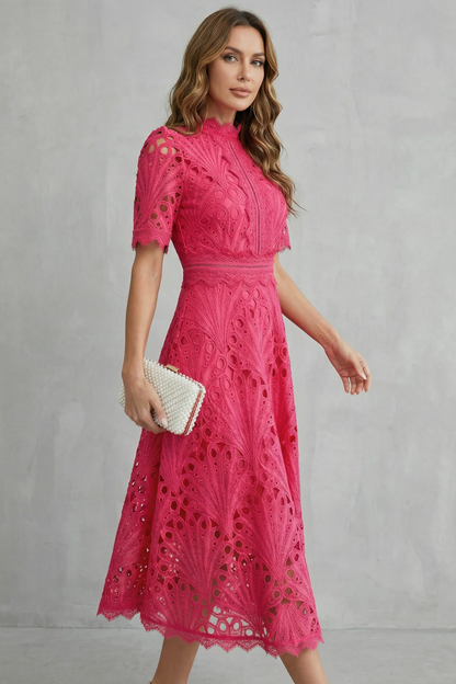 Side view of a fuchsia lace midi dress with a high neck, short sleeves, and a flared skirt design.