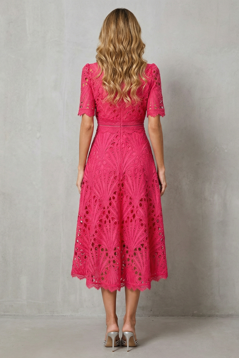 Back view of the fuchsia lace high neck midi dress, showing the full skirt and short sleeve details.