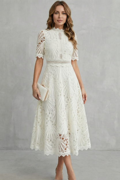 Front view of a white lace high neck midi dress with short sleeves and a textured design, holding a clutch.