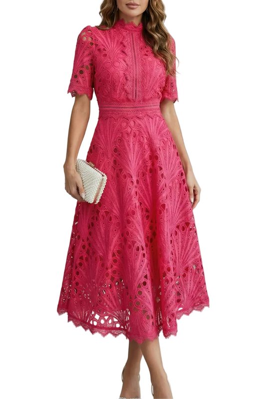 Bright fuchsia lace high neck midi dress with short sleeves and intricate cutouts, styled with a pearl clutch.