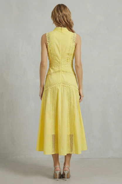 Back view of a yellow high neck midi dress for women, showcasing the sleeveless design and lace details down the back.