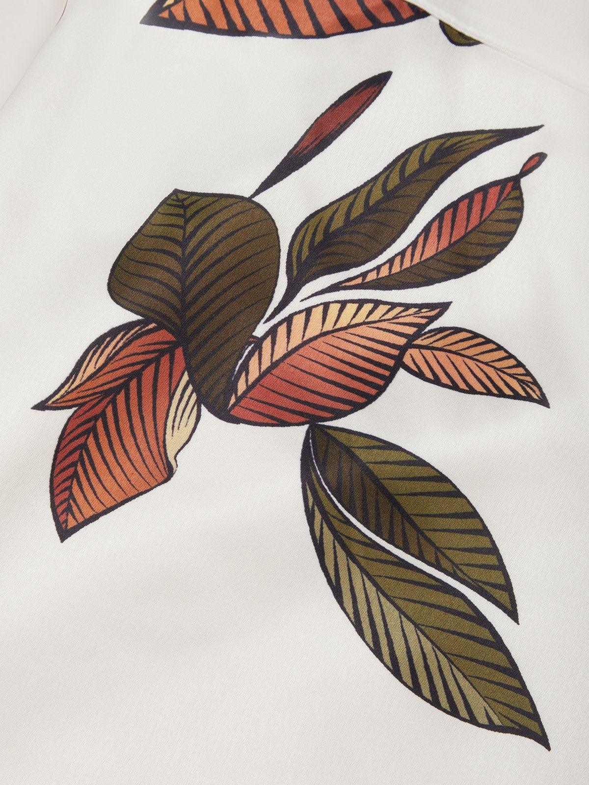 Sleeve detail on ivory summer maxi dress showing soft flutter short sleeve and leaf print near shoulder