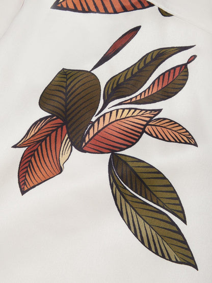 Sleeve detail on ivory summer maxi dress showing soft flutter short sleeve and leaf print near shoulder